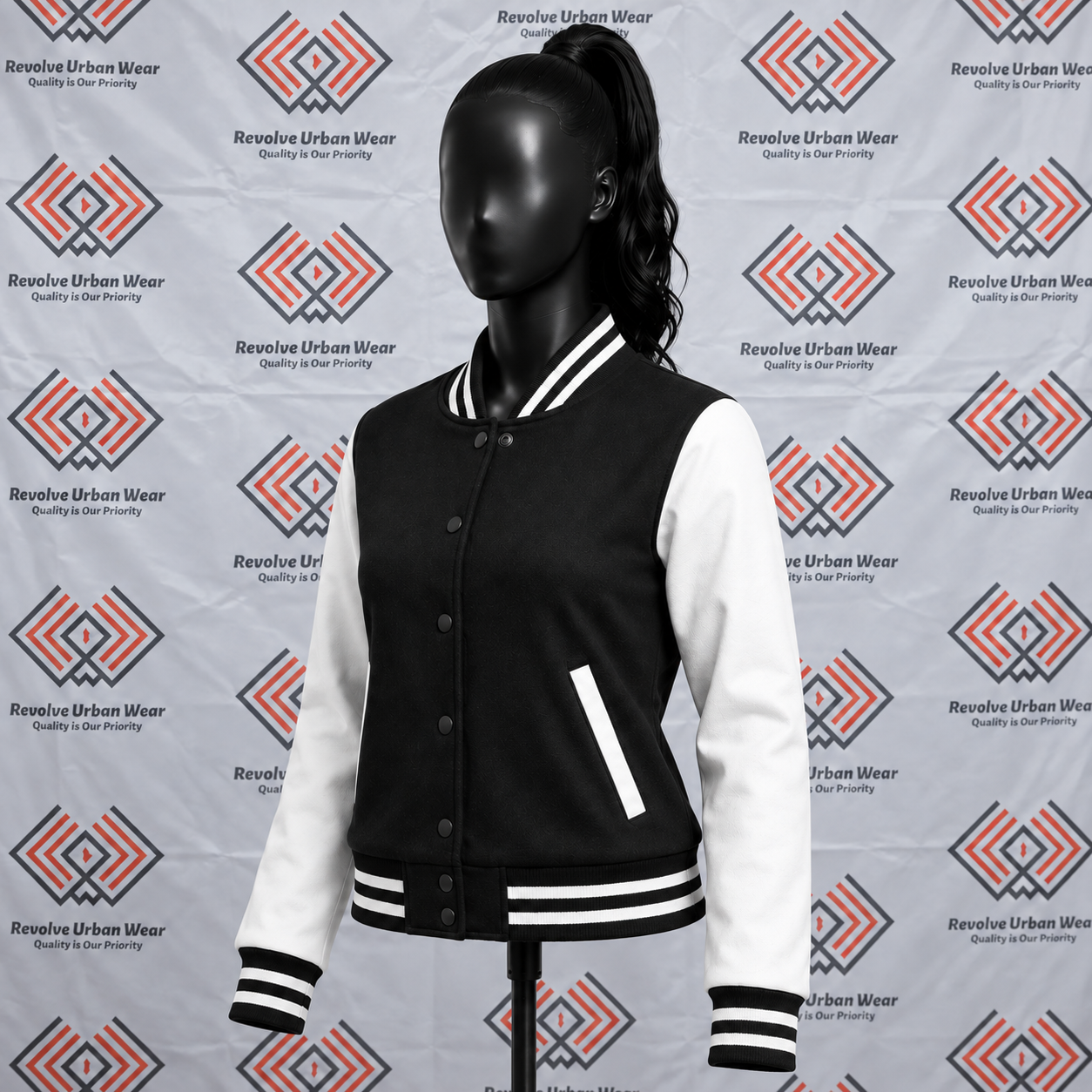 Black and white custom varsity jacket with leather sleeves and striped ribbed trims on a mannequin.