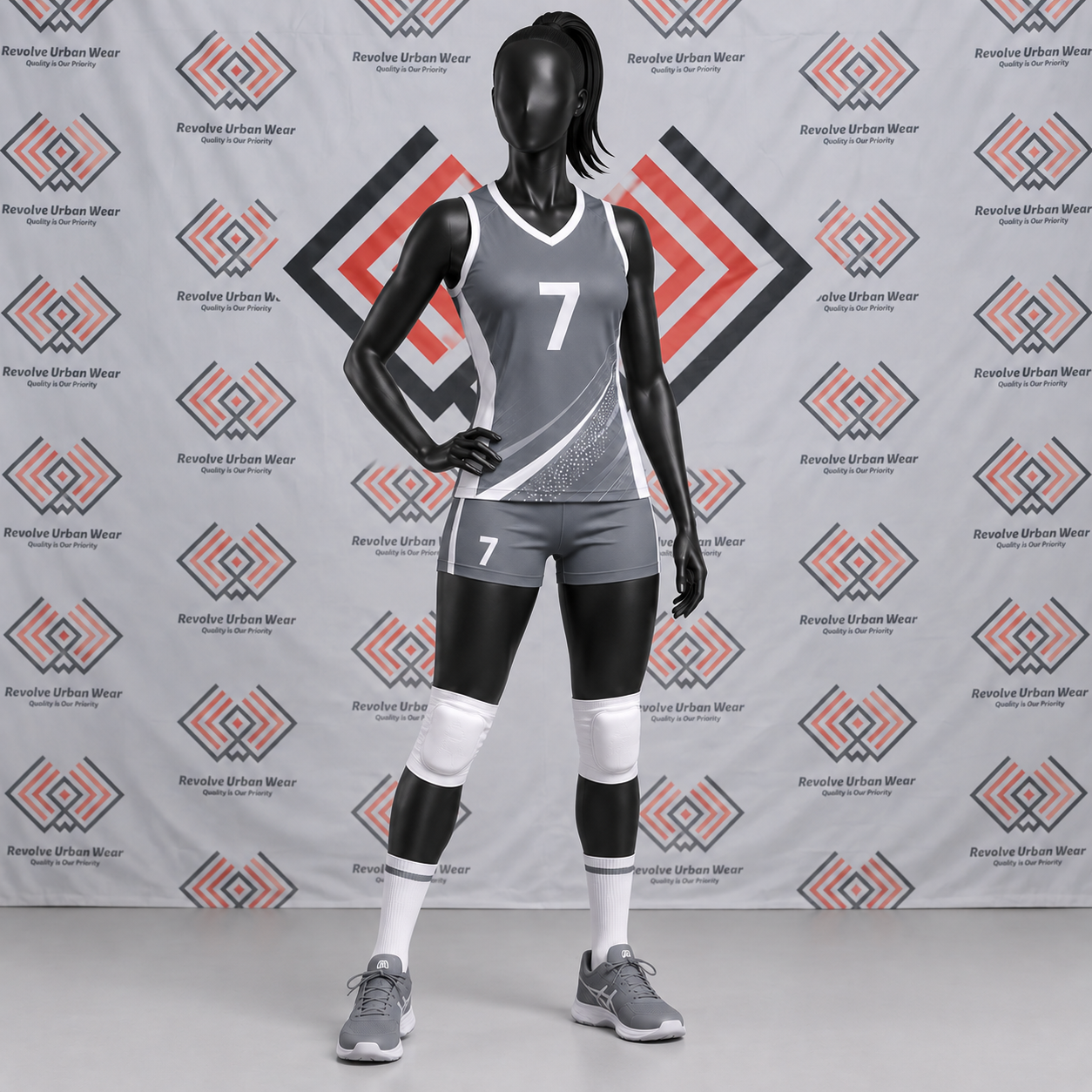 Custom grey and white sublimated volleyball uniform with diagonal accents on a mannequin.