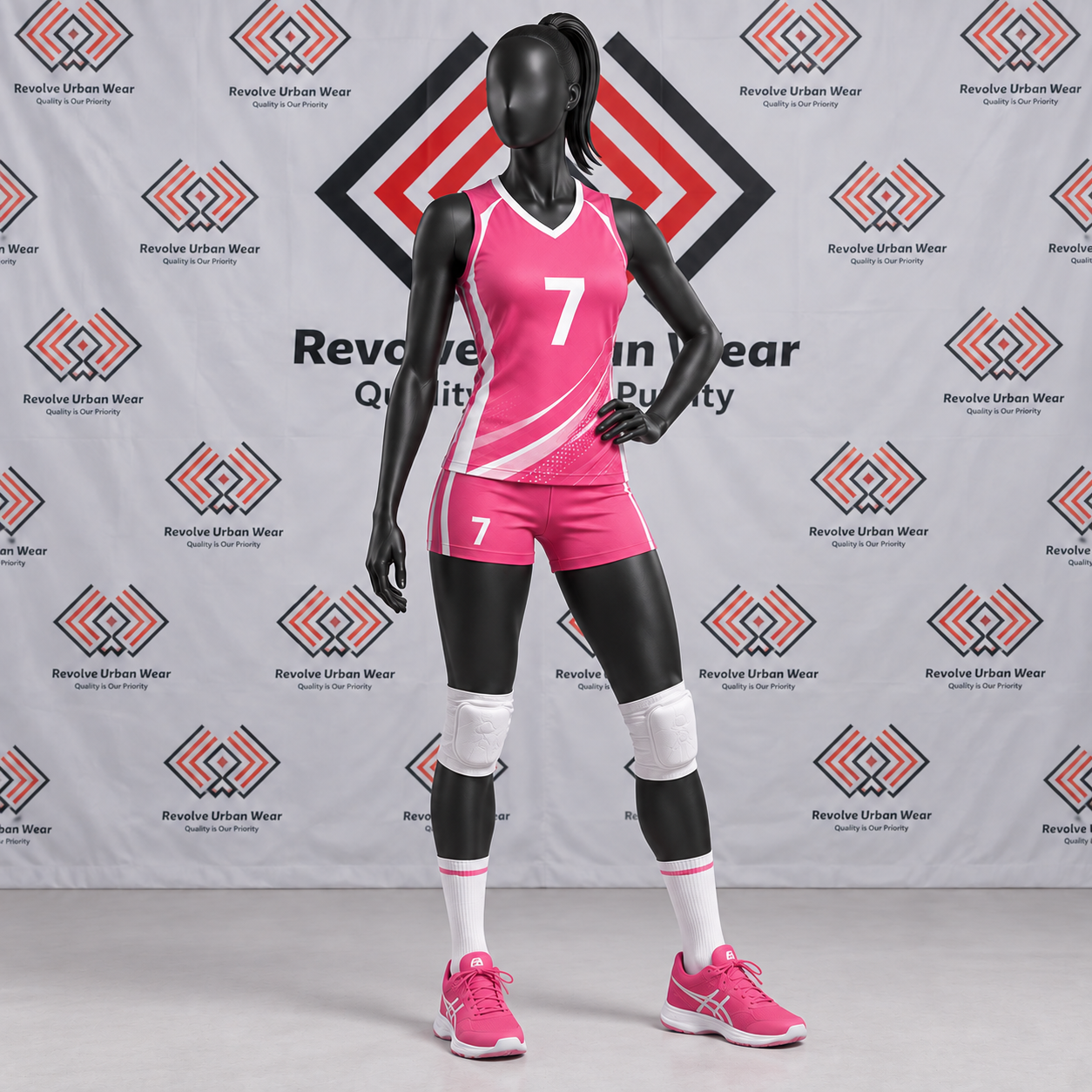 Custom pink and white women's volleyball uniform with diagonal accents on a mannequin.
