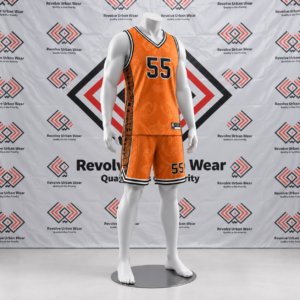Custom orange basketball uniform featuring a V-neck collar, black and white trim, tonal Māori patterns, and black patterned side panels on a mannequin.