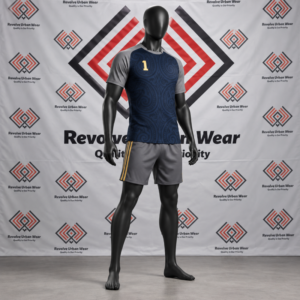 Custom navy rugby league uniform featuring tonal Māori torso patterns, grey raglan sleeves, and grey shorts with gold stripes on a mannequin.