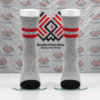 Custom grey and red crew socks featuring ribbed cuffs and black reinforced toe panels on leg mannequins.