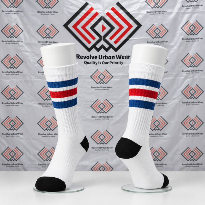 Custom white red and blue crew socks featuring ribbed cuffs and black reinforced heel and toe panels on leg mannequins.